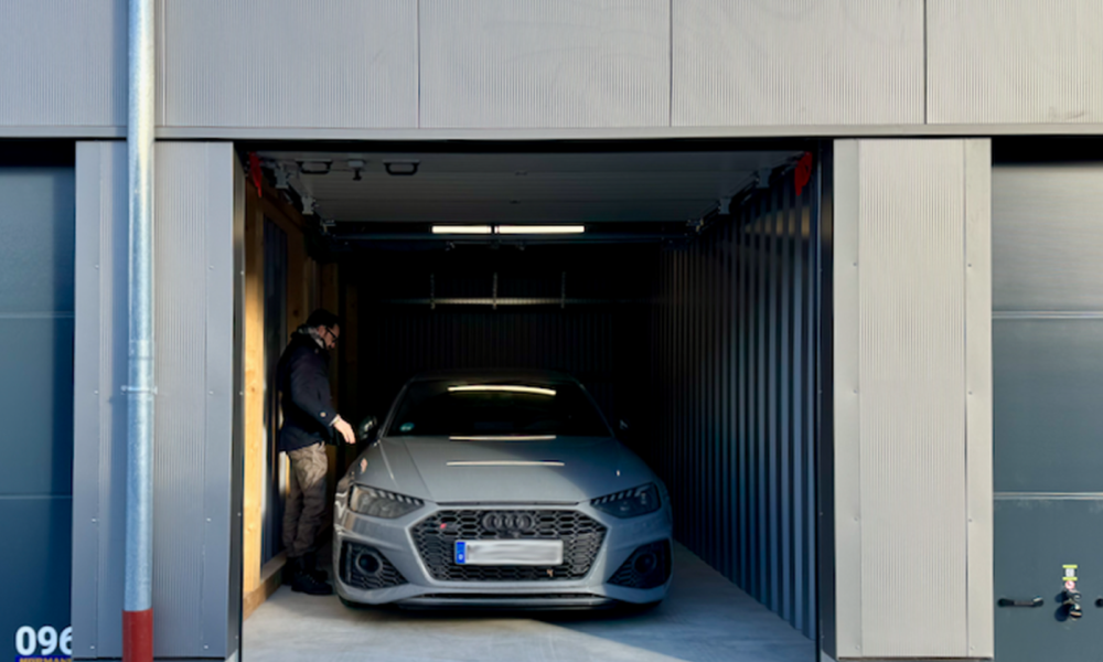 A self-storage unit with a car inside it.